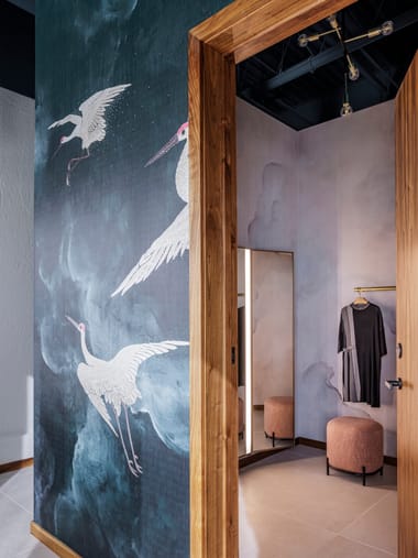Fitting suite doorway framed by the crane mural and timber column