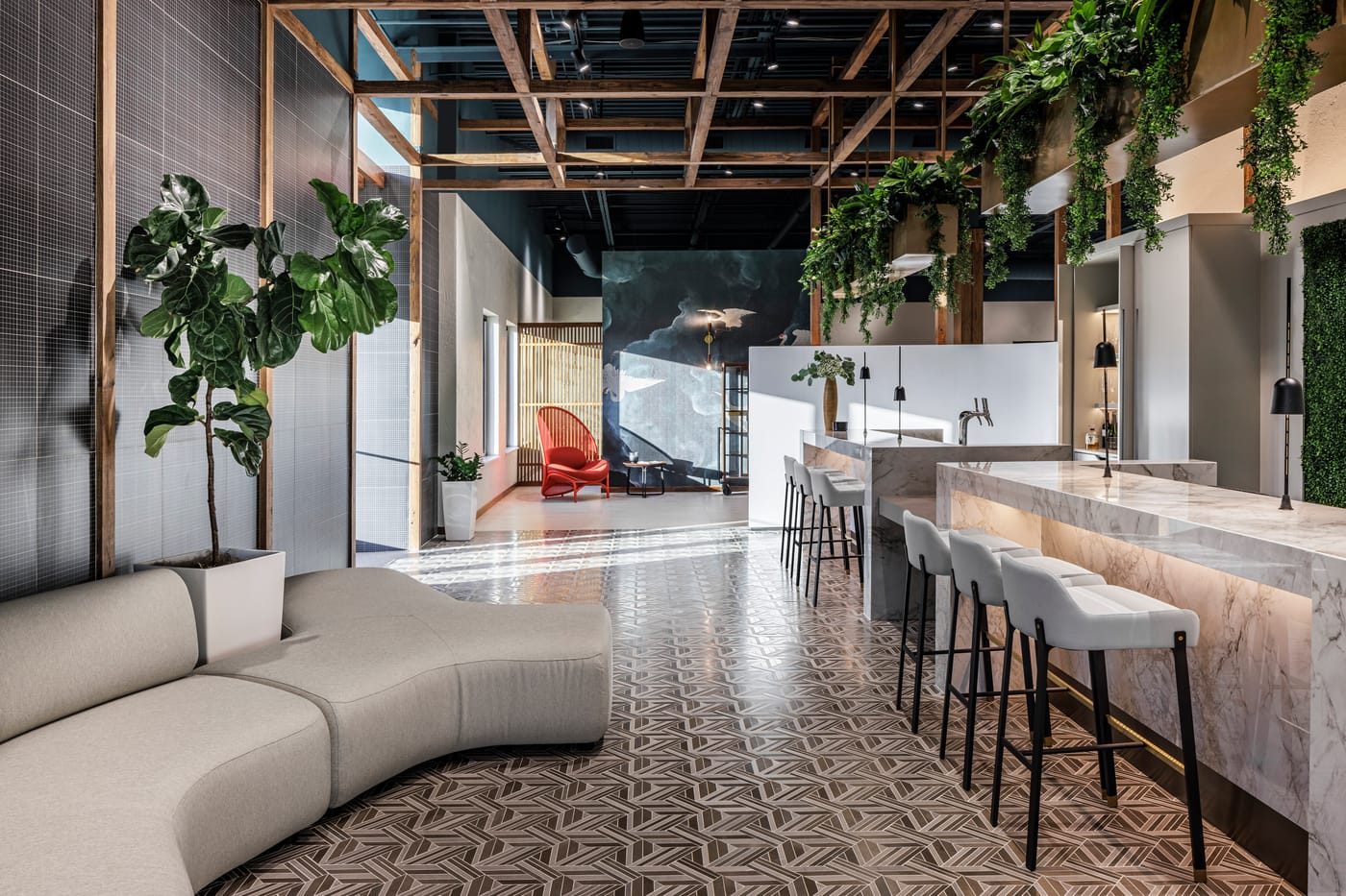 Marble bar with hanging greenery, lounge seating, and patterned mosaic tile floors inside 415 S. Kimball Avenue